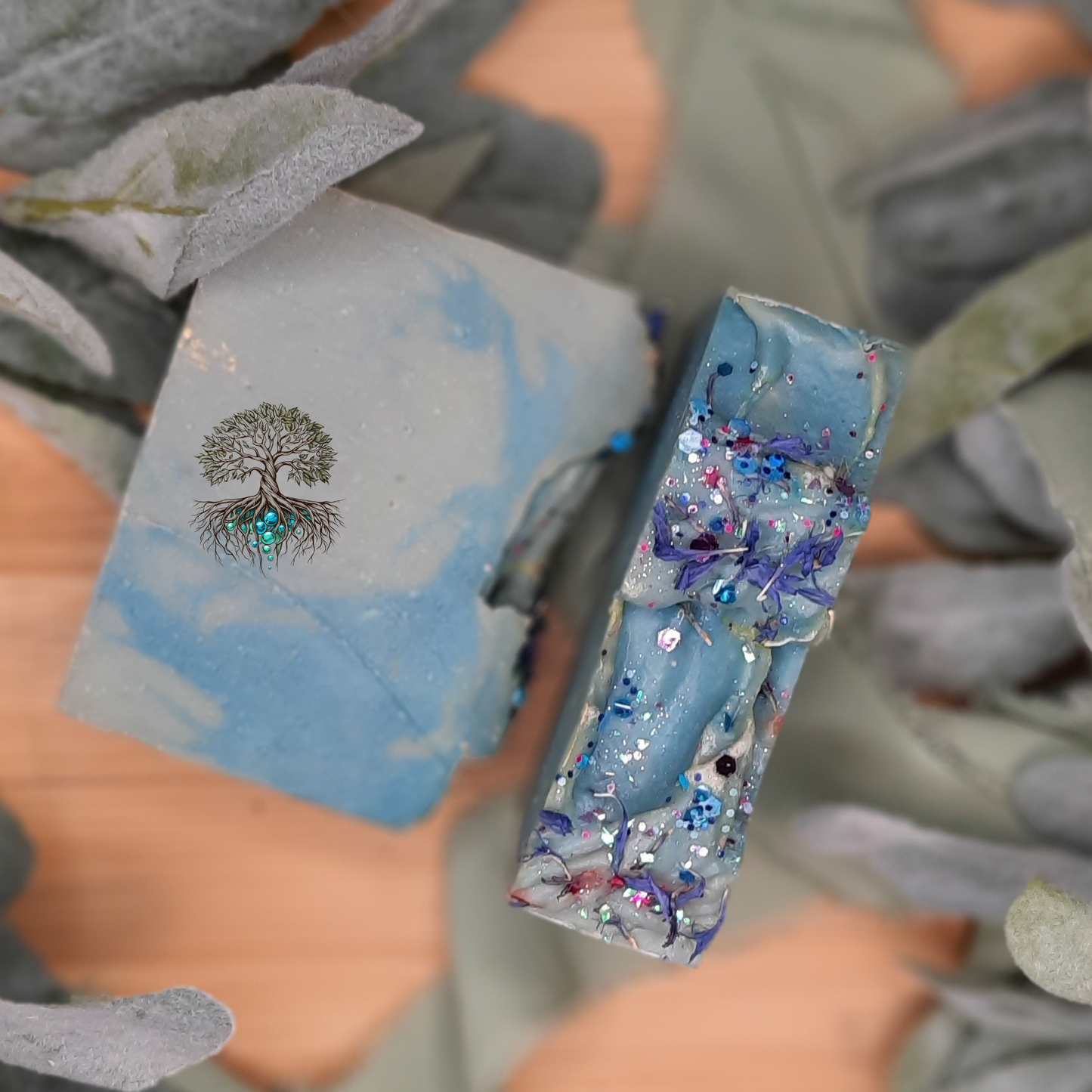 Adara hemp soap bar, light and medium blue swirl soap bar with blue botanicals and biodegradable glitter on top. Handmade hemp oil soap bar.