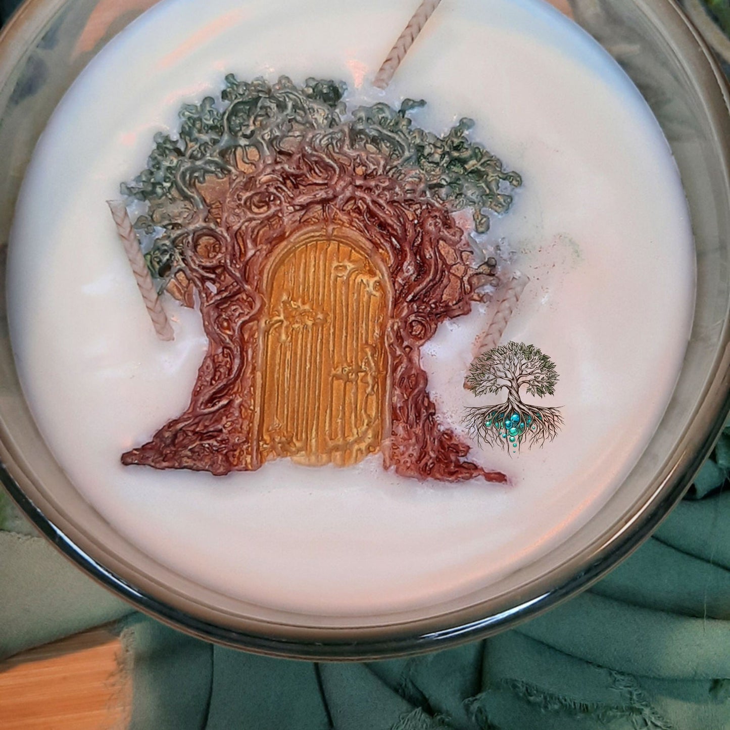 Candle with a decorative tree and door design on top