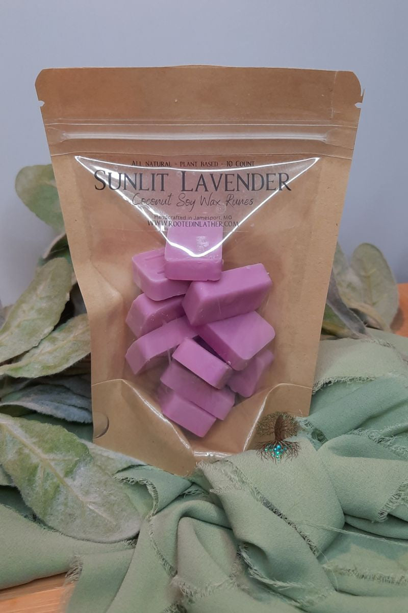 Sunlit Lavender wax melts in a brown paper bag with green leaves in the background