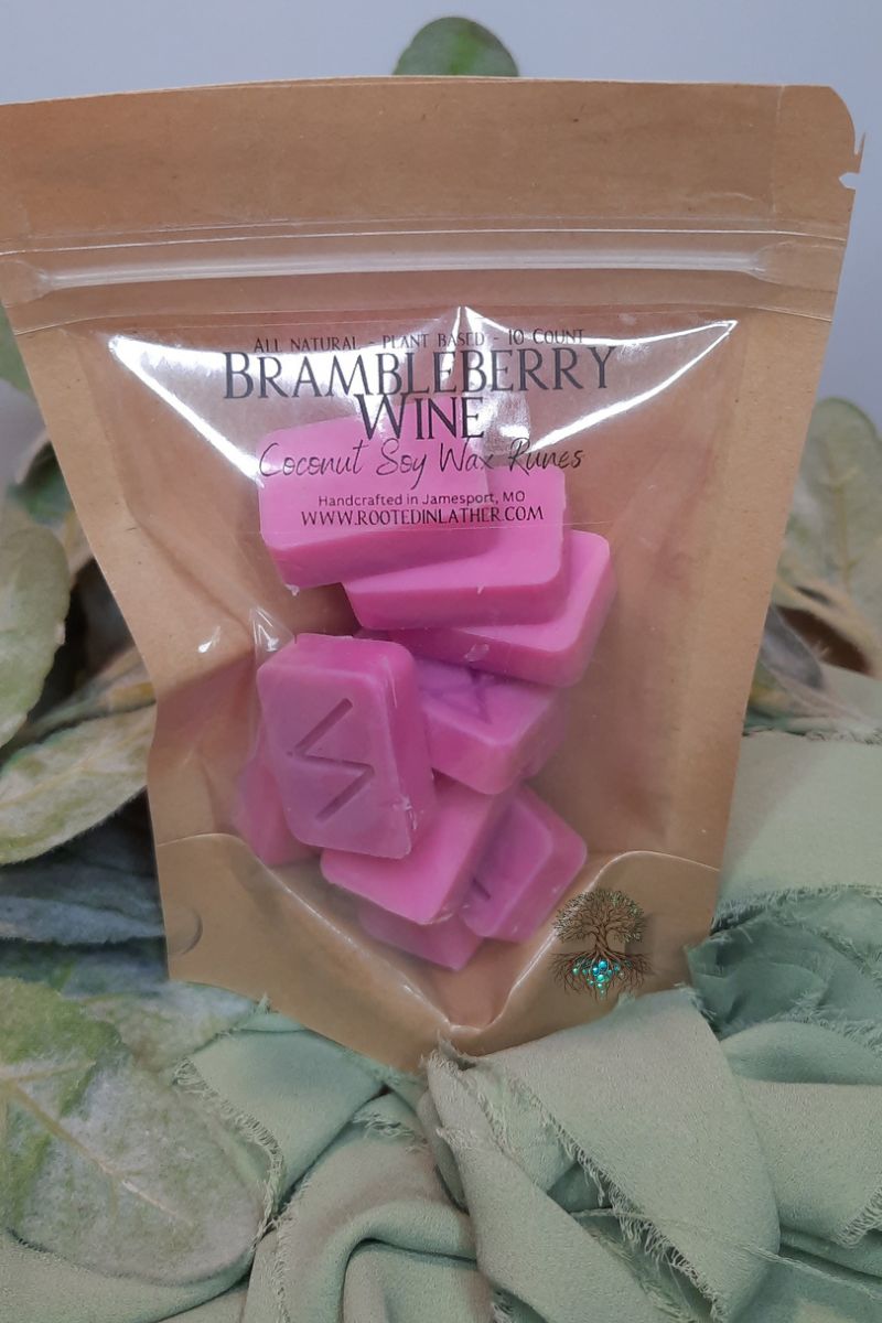 Pink wax melts in a clear plastic bag inside a brown package labeled 'Brambleberry Wine'.