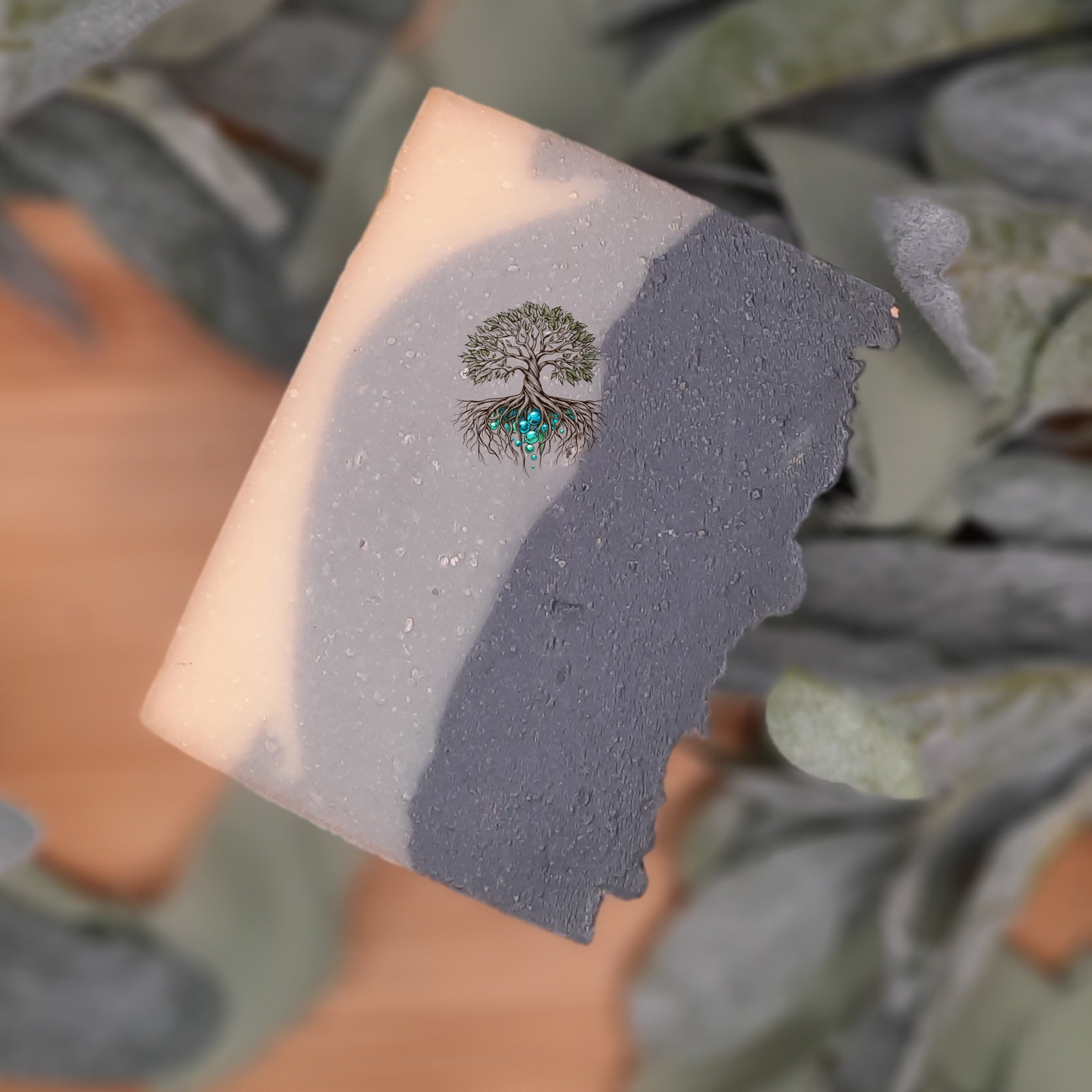 Aurelius hemp soap bar, layered soap bar, white on the bottom light grey middle layer, dark grey top layer. Scented in bergamont and black tea.