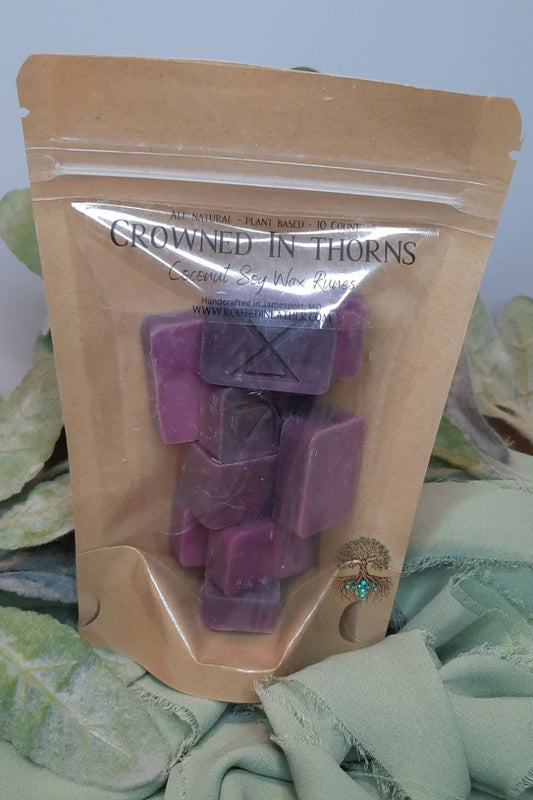 Packaged wax melts with 'Crowned in Thorns' branding on a leafy background