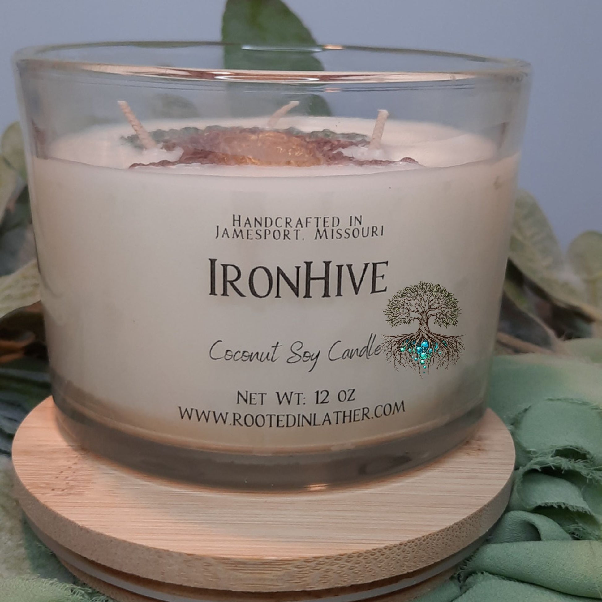 Coconut soy candle with Ironhive branding on a wooden coaster