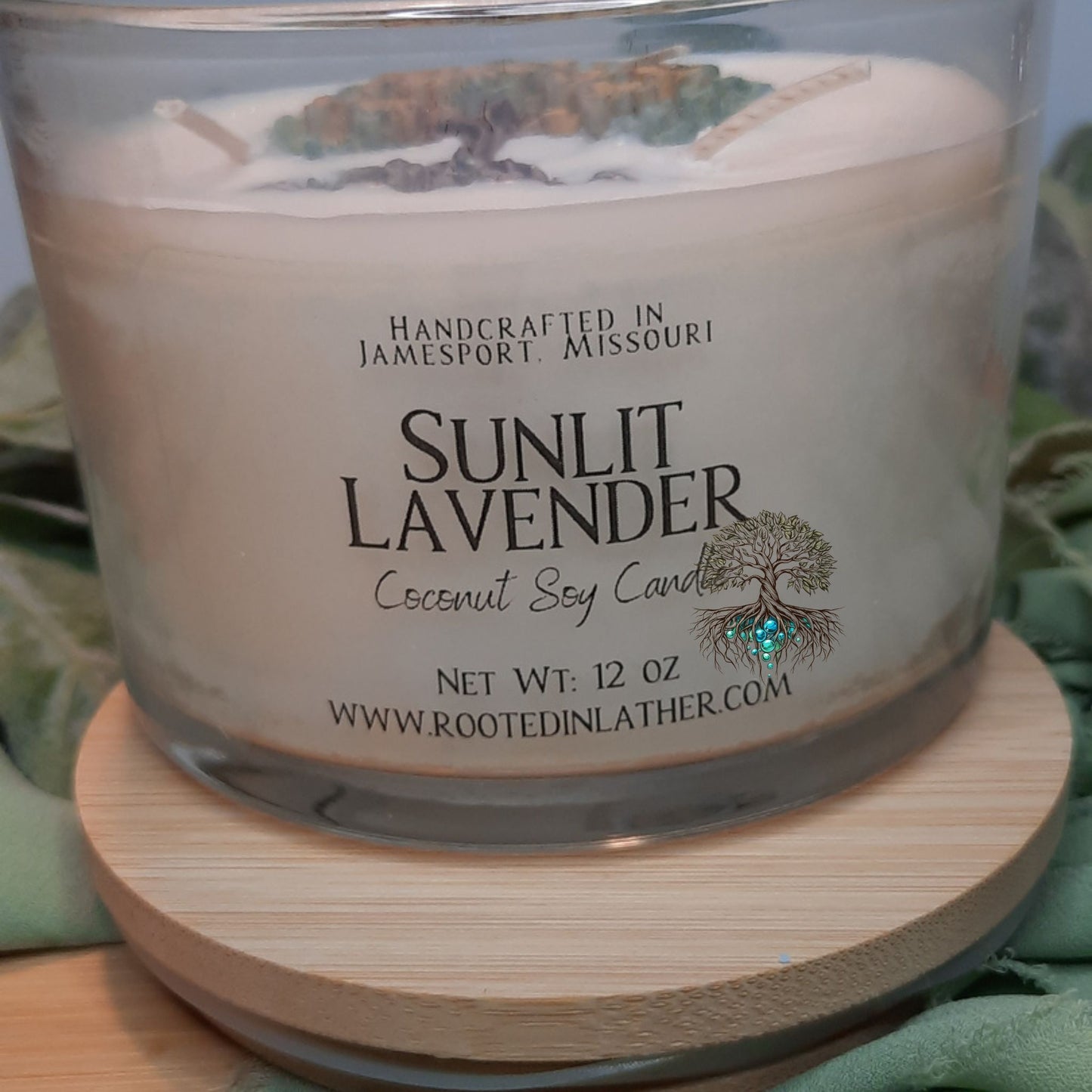 Sunlit Lavender candle with a label on a wooden coaster