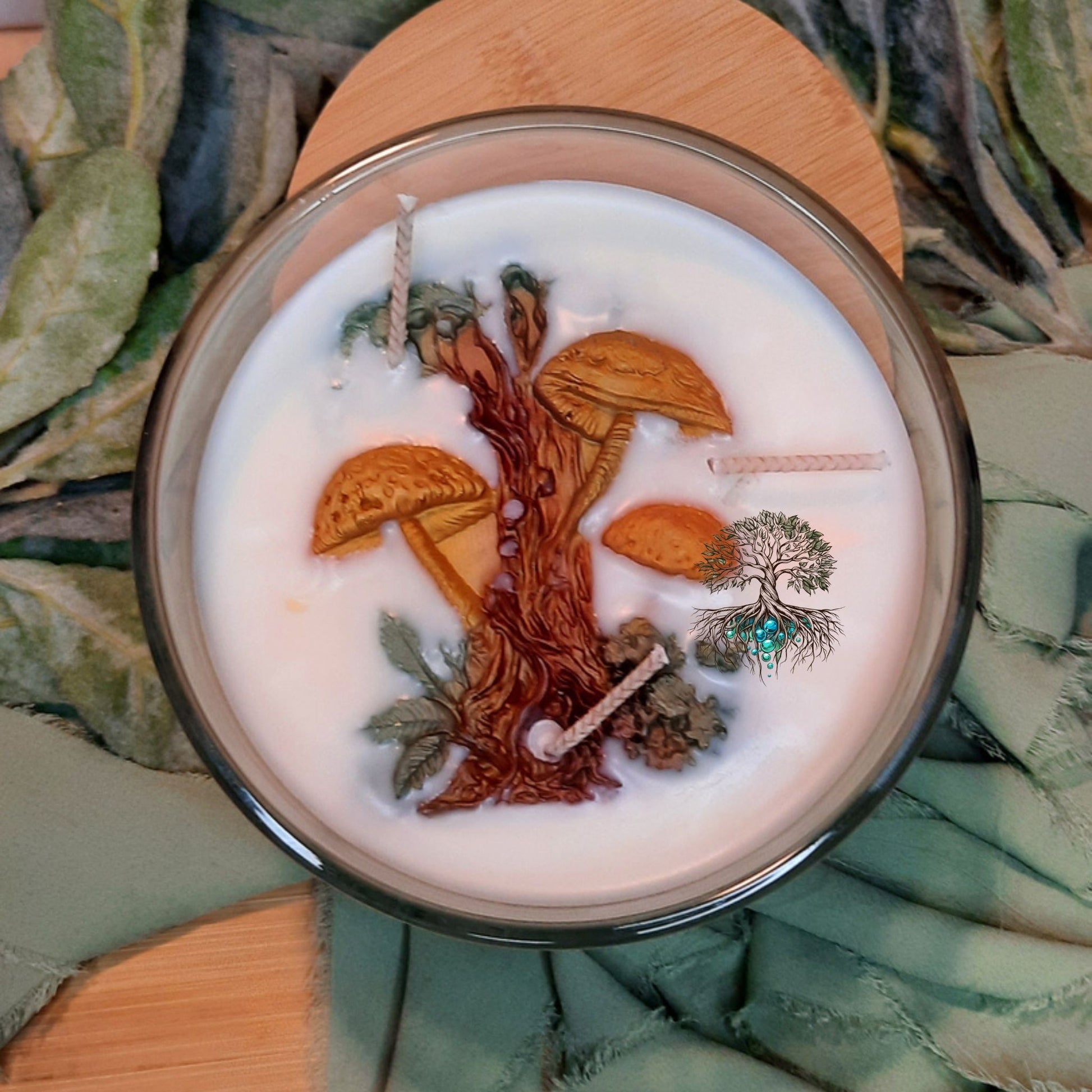 Candle with nature-themed design on a leafy background