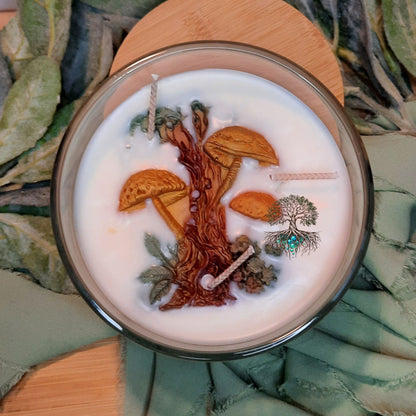 Candle with nature-themed design on a leafy background