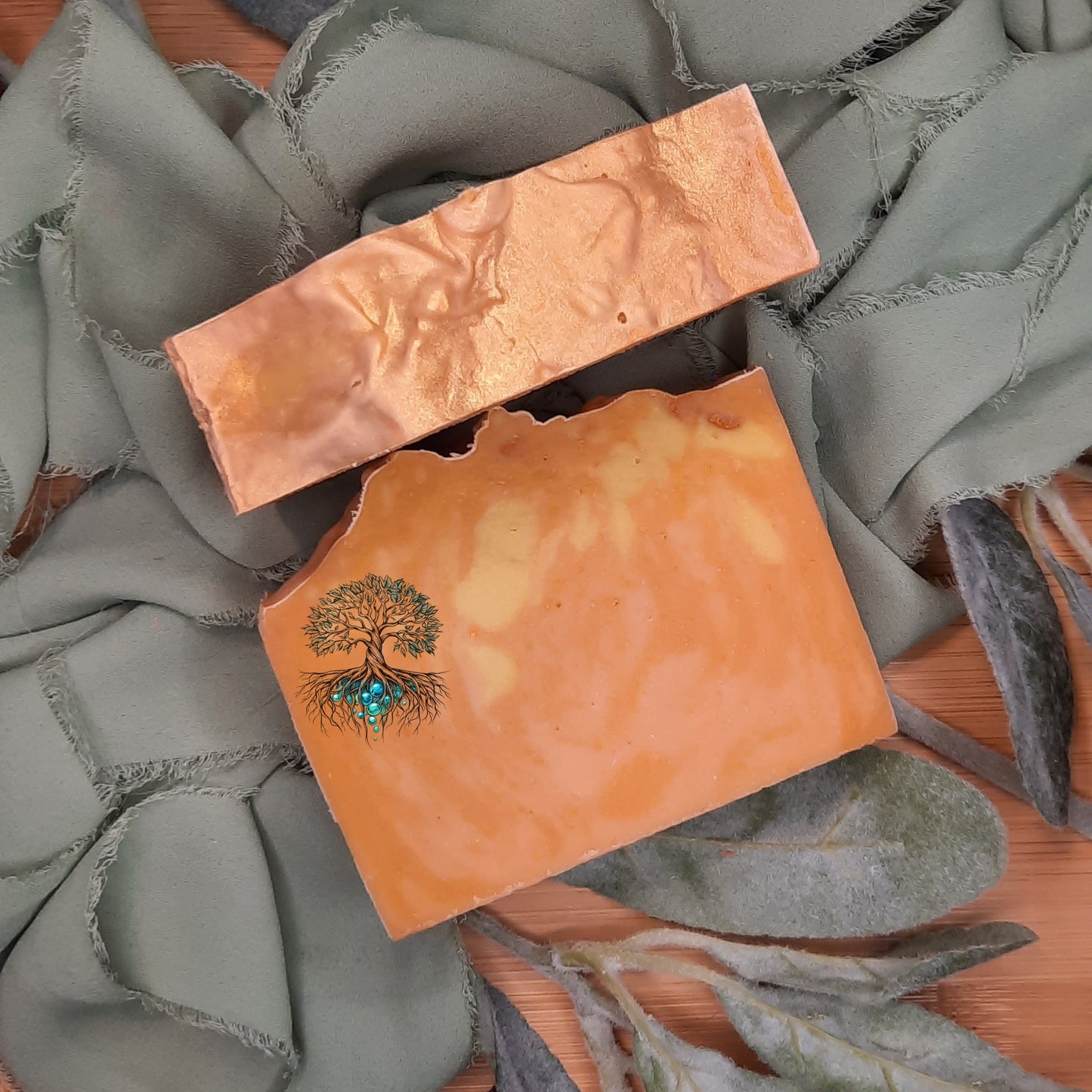 Two soap bars with tree designs on a textured surface