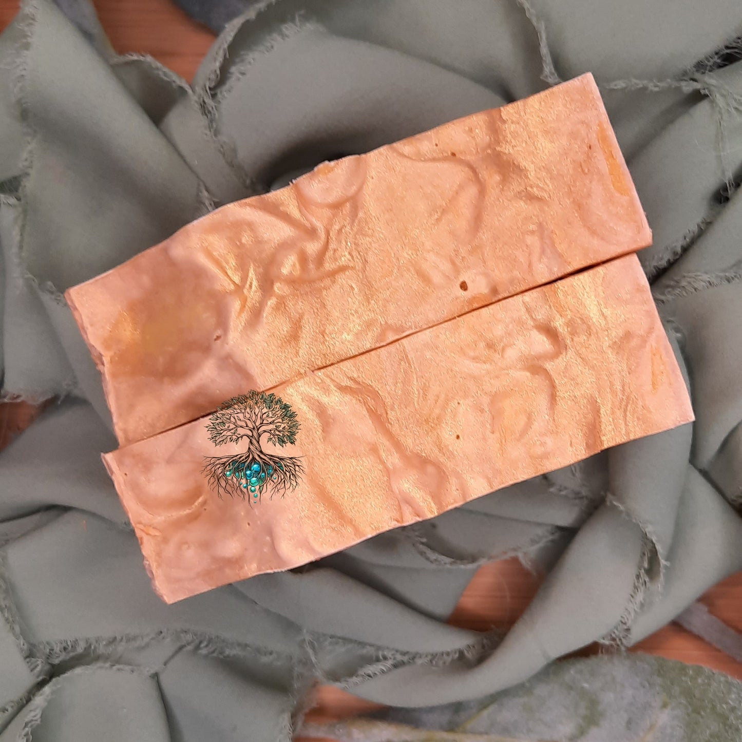 Copper-colored product with a tree design on a textured gray surface