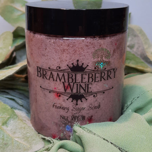 Jar of Brambleberry Wine body scrub on a green leafy background